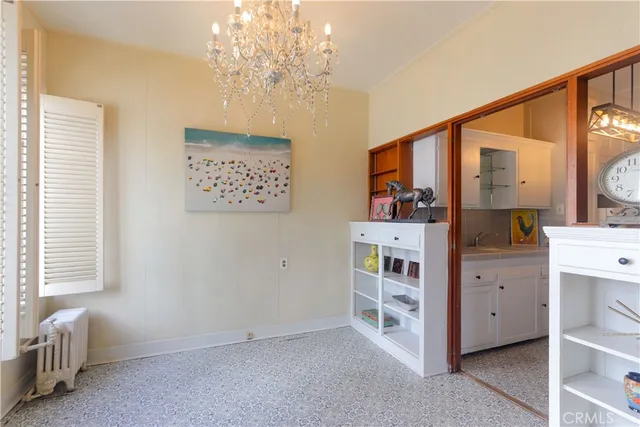 a view of hallway with windows and chandelier