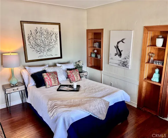 a bedroom with a bed and a painting on the wall