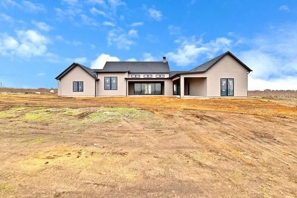 a big house with a big yard and large trees