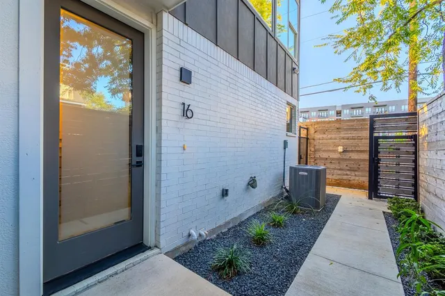 a view of a pathway with a potted plants in front of door