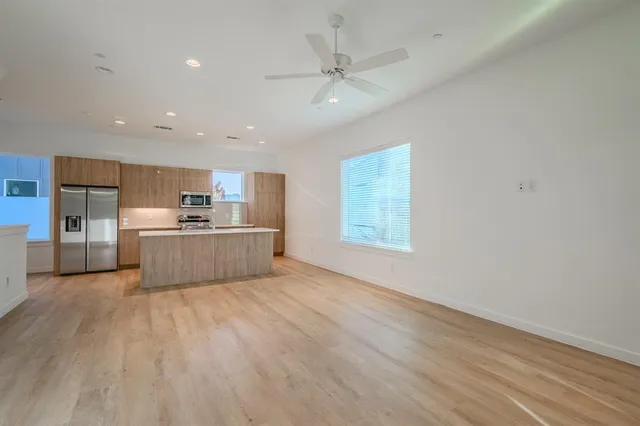 a view of a kitchen with a sink cabinets and wooden floor