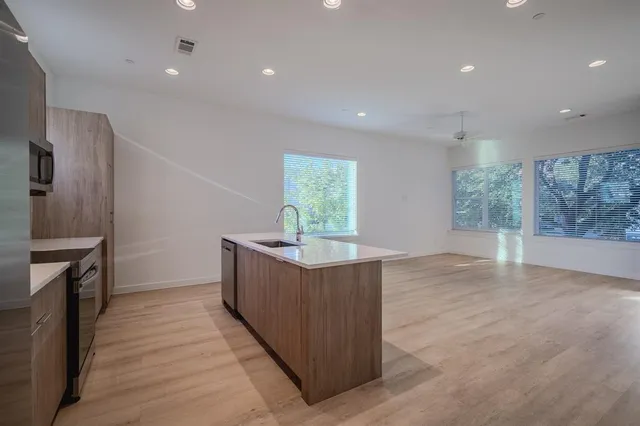 a kitchen with stainless steel appliances granite countertop a stove and a sink