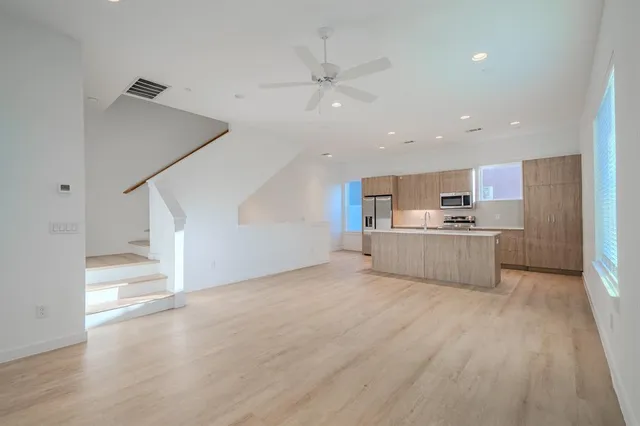 a view of kitchen with wooden floor and electronic appliances
