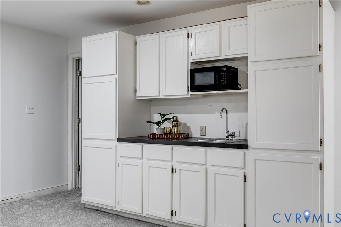 509 Wadeward Road Henrico, VA 23229 - Photo 51 of 59 a kitchen with white cabinets and stainless steel appliances