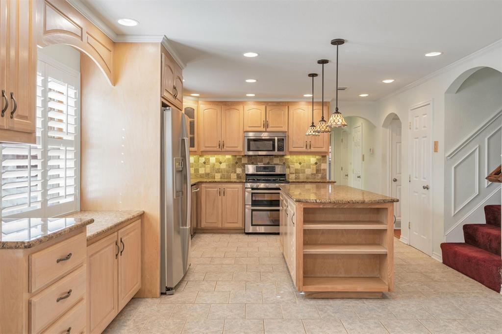 1832 Wonderlight Lane Dallas, TX 75228 - Photo 13 of 39 a kitchen with stainless steel appliances kitchen island granite countertop a refrigerator and a sink