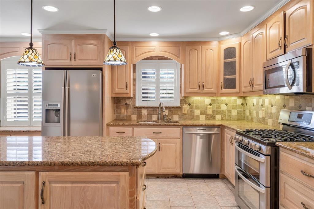 1832 Wonderlight Lane Dallas, TX 75228 - Photo 15 of 39 a kitchen with stainless steel appliances granite countertop a stove a sink and a granite counter tops