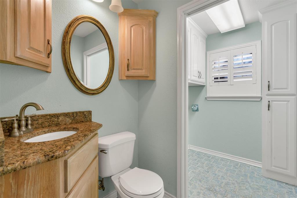 1832 Wonderlight Lane Dallas, TX 75228 - Photo 17 of 39 a bathroom with a granite countertop toilet sink and mirror