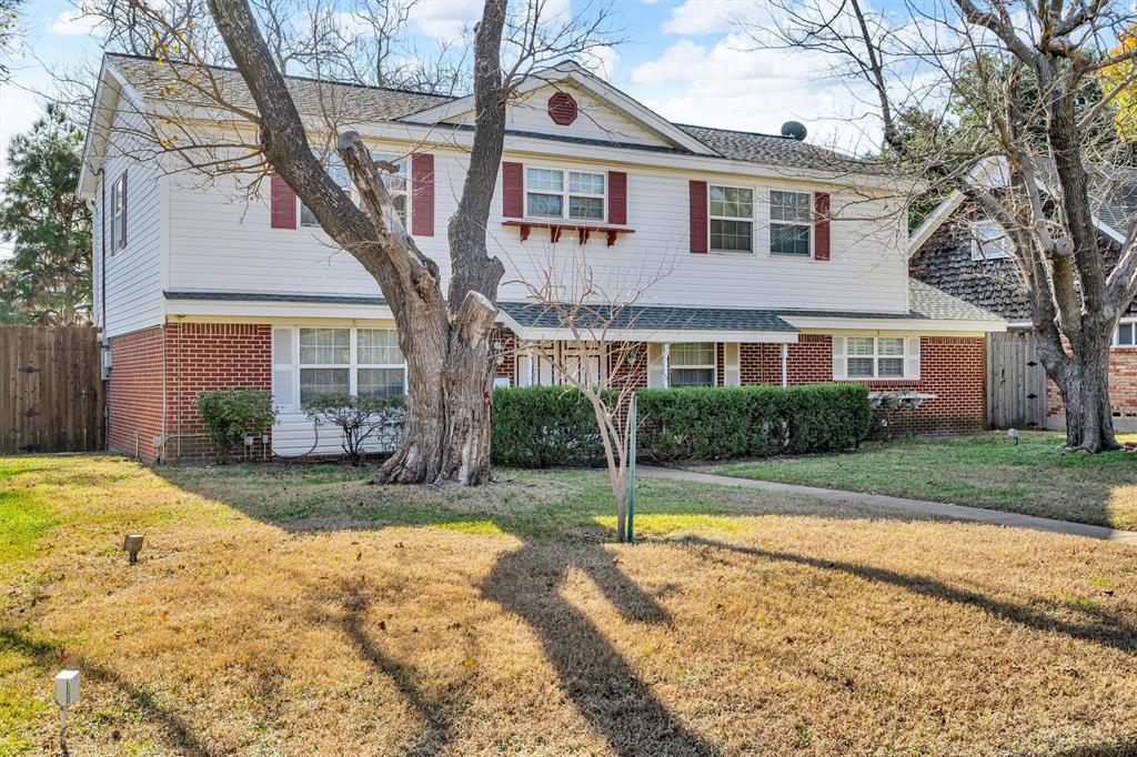 1832 Wonderlight Lane Dallas, TX 75228 - Photo 2 of 39 a front view of a house with a yard and trees