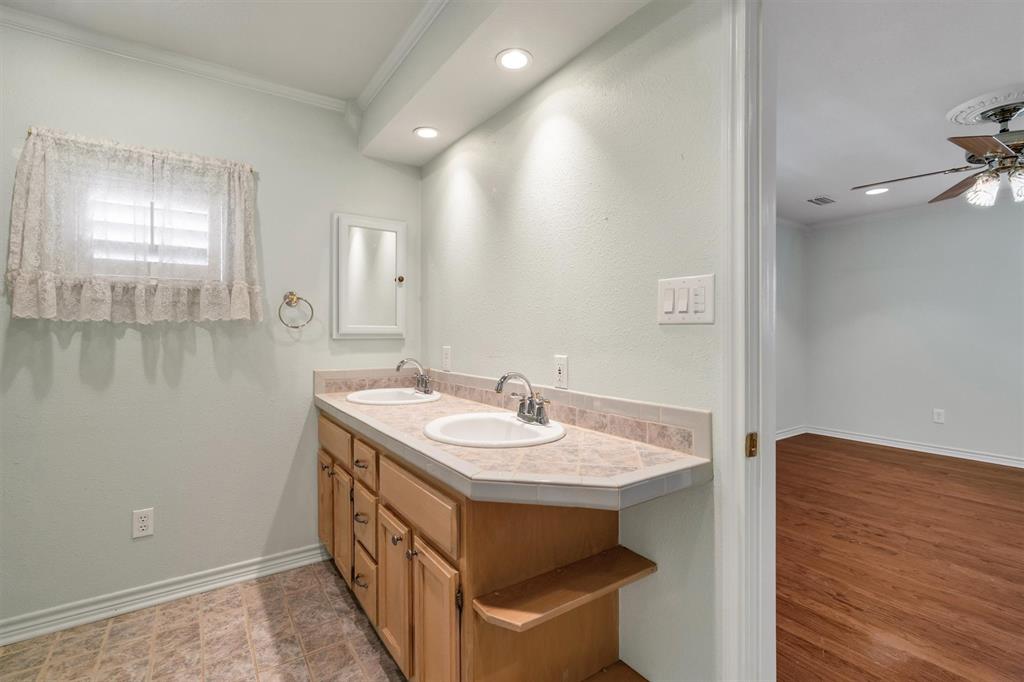 1832 Wonderlight Lane Dallas, TX 75228 - Photo 23 of 39 a bathroom with a sink and a mirror