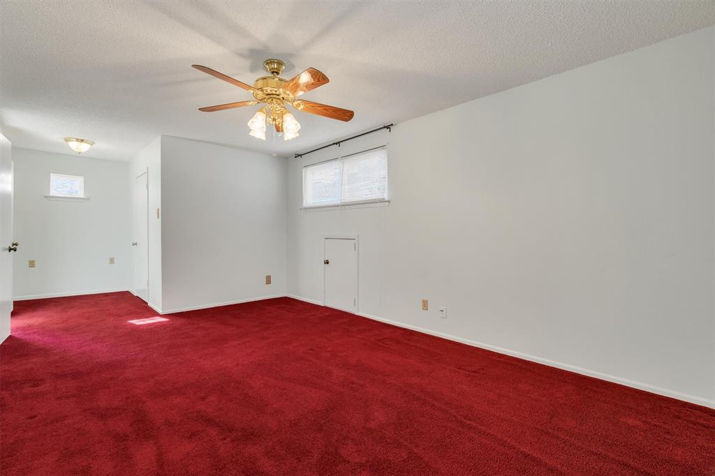 1832 Wonderlight Lane Dallas, TX 75228 - Photo 25 of 39 an empty room with a window and a ceiling fan