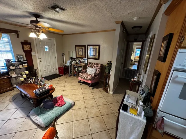 a living room with furniture a flat screen tv and rug
