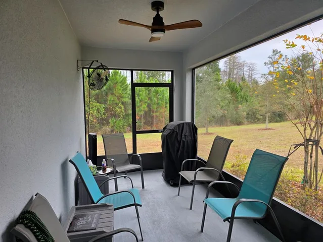 a view of a livingroom with furniture and a large window