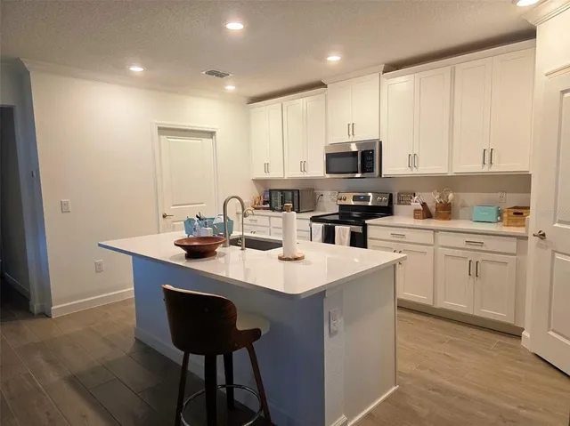 a kitchen with a sink cabinets and stainless steel appliances