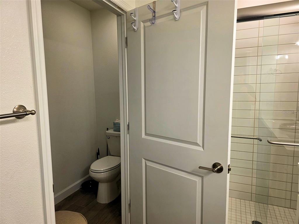 16890 Forge Surf Street Land O Lakes, FL 34638 - Photo 22 of 26 a bathroom with a toilet and a shower