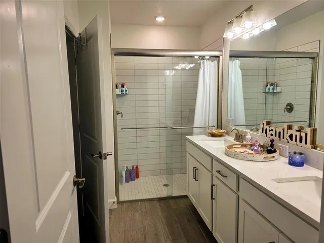 a bathroom with a double vanity sink and mirror
