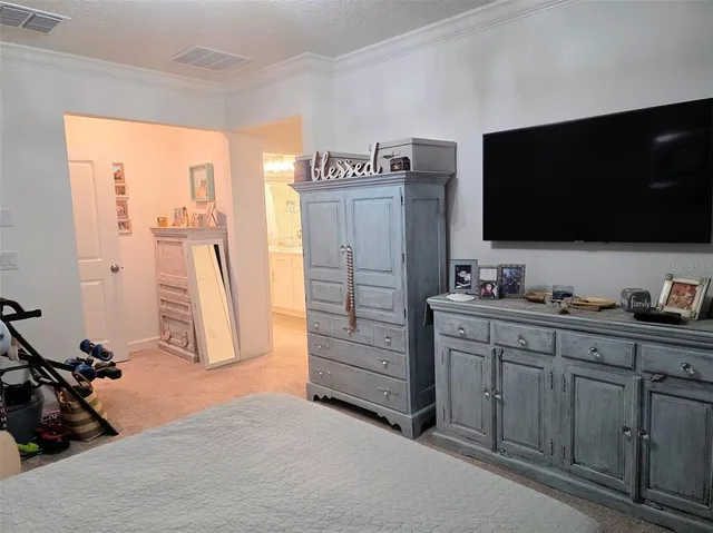 a view of room with wooden floor and flat screen tv