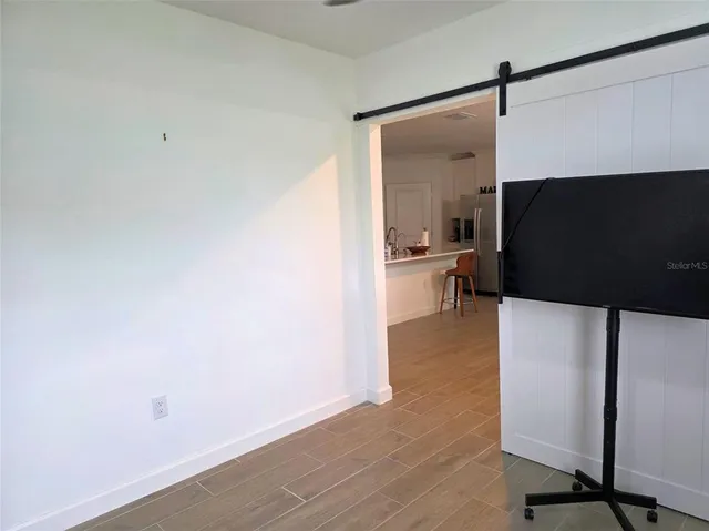 a view of living room with furniture and a flat screen tv