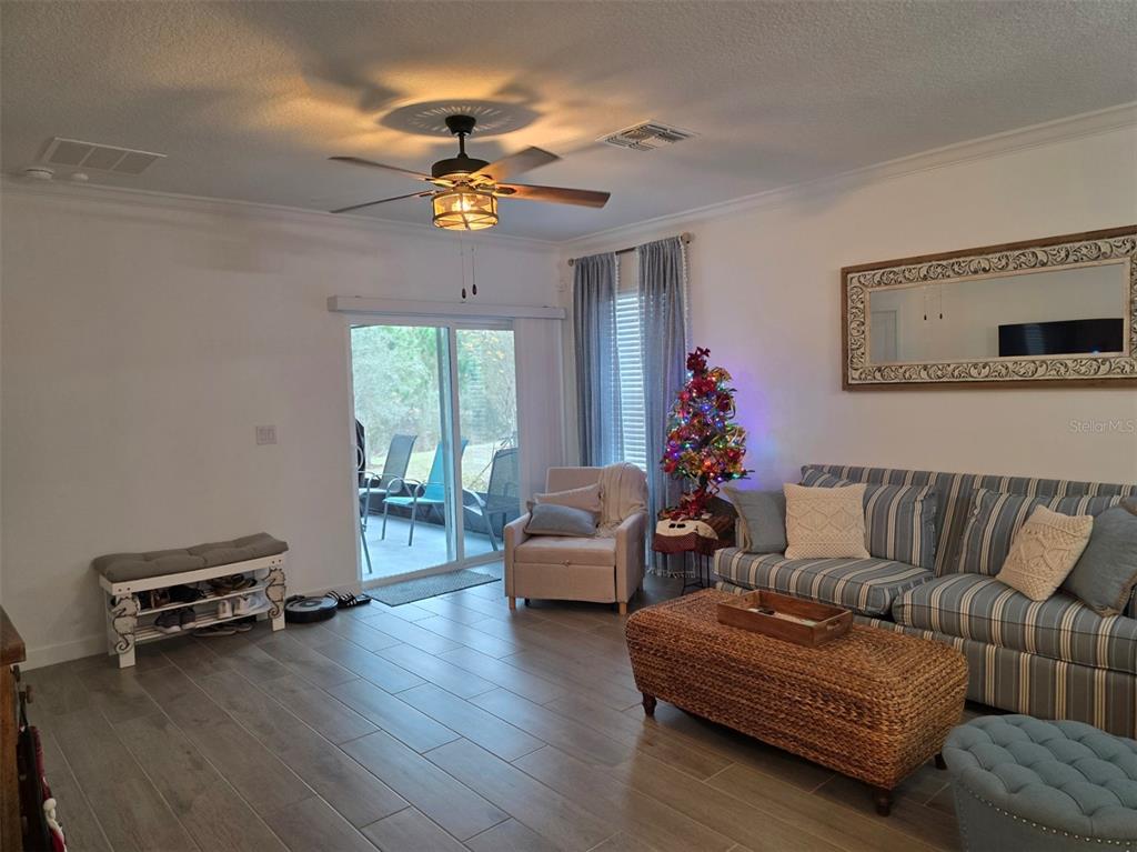 16890 Forge Surf Street Land O Lakes, FL 34638 - Photo 7 of 26 a living room with furniture and wooden floor
