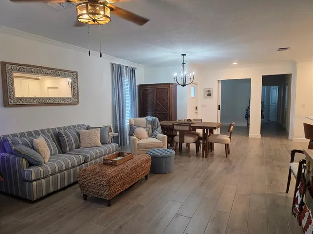 a living room with furniture and a chandelier