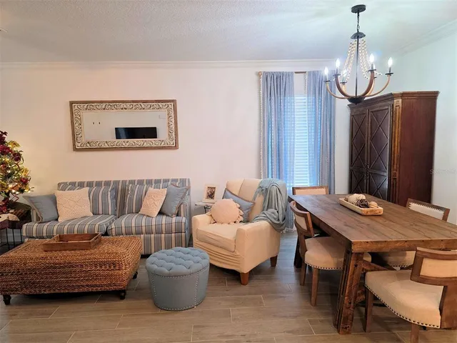 a living room with furniture and a chandelier