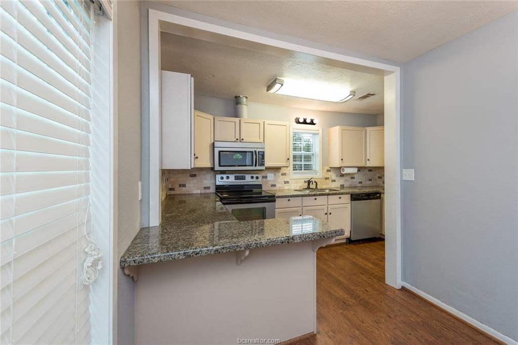 112 Sulphur Springs Road Bryan, TX 77801 - Photo 5 of 17 a kitchen with stainless steel appliances a sink stove and cabinets