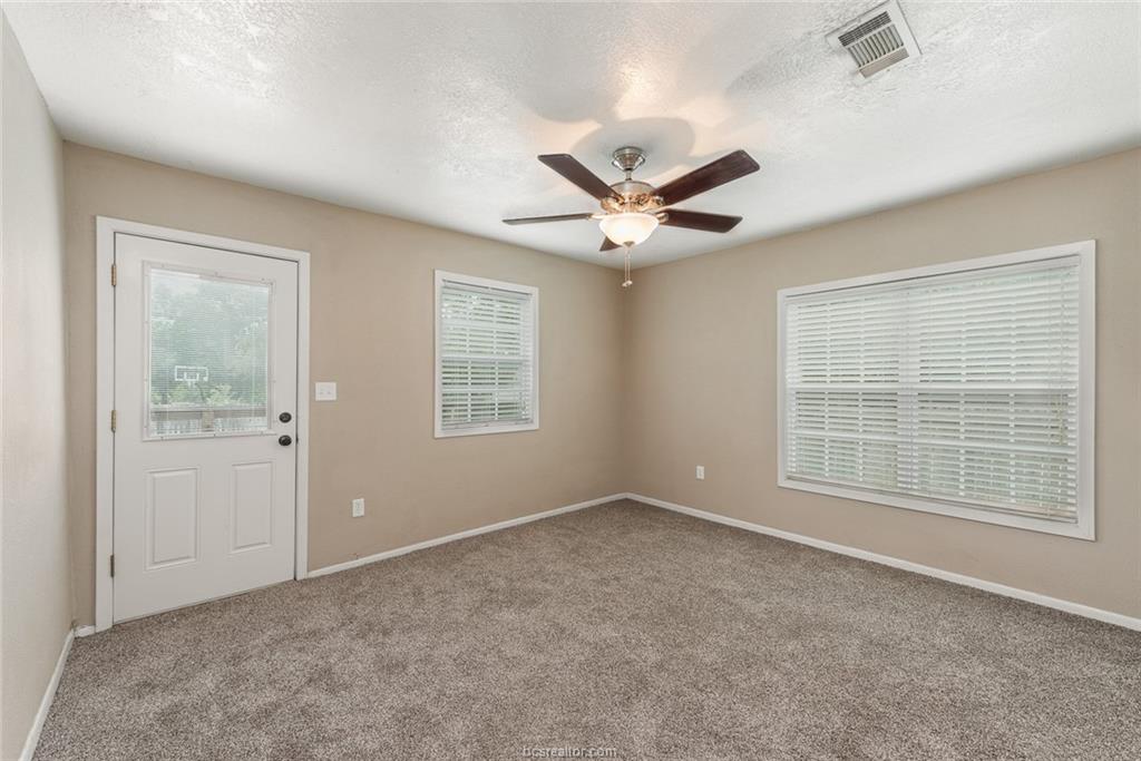 112 Sulphur Springs Road Bryan, TX 77801 - Photo 8 of 17 an empty room with a window and a fan