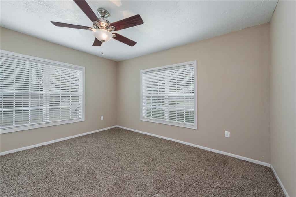 112 Sulphur Springs Road Bryan, TX 77801 - Photo 10 of 17 an empty room with chandelier fan and windows