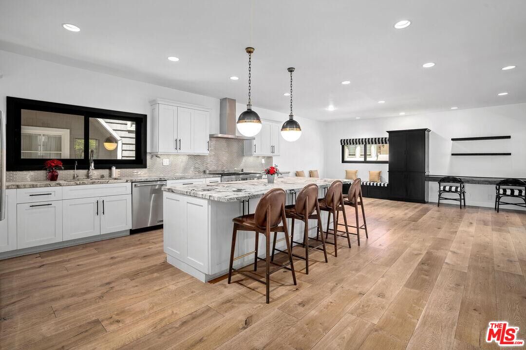 4811 Roma Court Marina del Rey, CA 90292 - Photo 17 of 57 a kitchen with a table chairs sink and cabinets