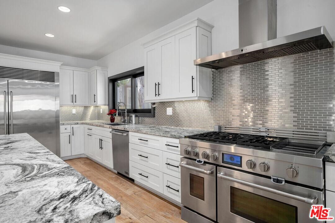 4811 Roma Court Marina del Rey, CA 90292 - Photo 19 of 57 a kitchen with granite countertop cabinets stainless steel appliances and a window