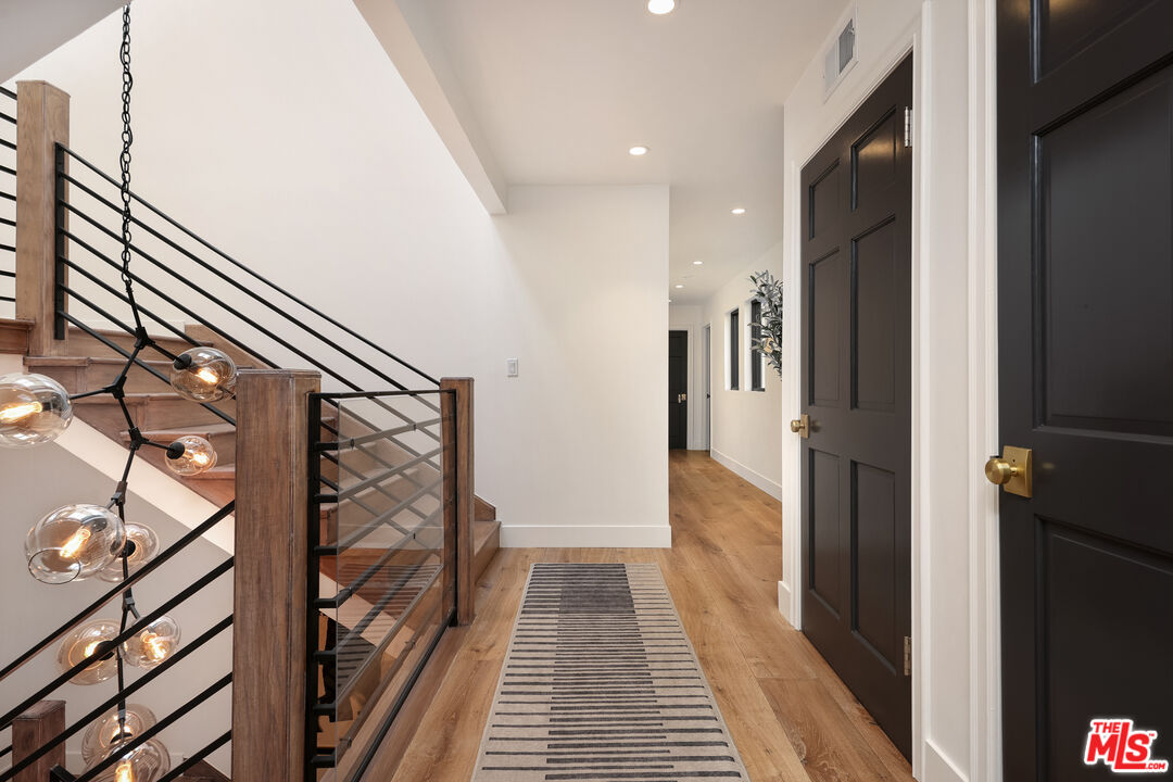 4811 Roma Court Marina del Rey, CA 90292 - Photo 25 of 57 a view of a hallway with wooden floor and staircase