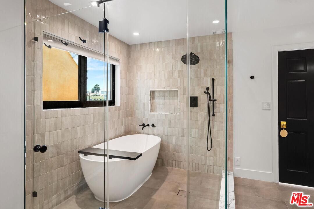 4811 Roma Court Marina del Rey, CA 90292 - Photo 30 of 57 a bathroom with a granite countertop sink a mirror and shower