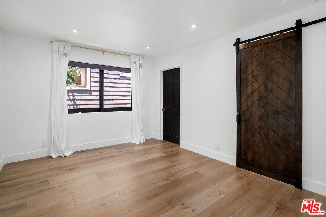4811 Roma Court Marina del Rey, CA 90292 - Photo 35 of 57 a view of an empty room with wooden floor and a window