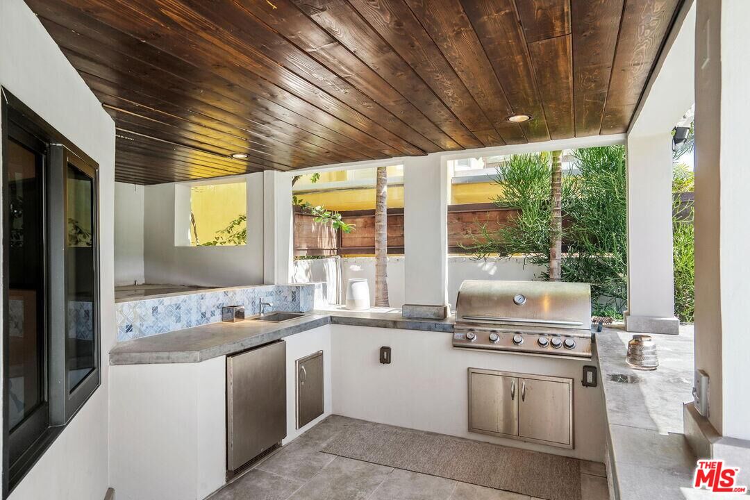 4811 Roma Court Marina del Rey, CA 90292 - Photo 53 of 57 a kitchen with a stove a sink and a refrigerator