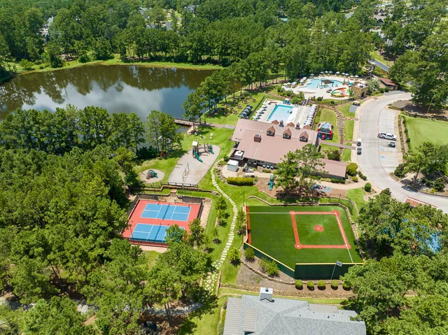 an aerial view of a house with a yard and lake view