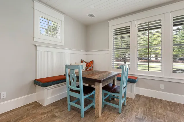 a dining room with furniture and wooden floor
