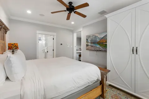 a bedroom with a bed and a chandelier