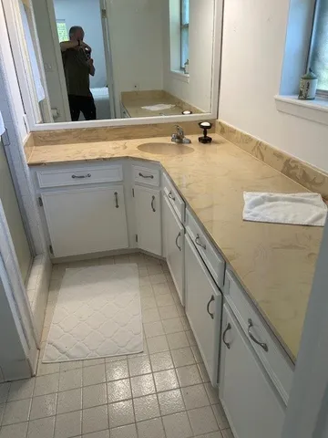 a kitchen with stainless steel appliances a refrigerator sink and cabinets