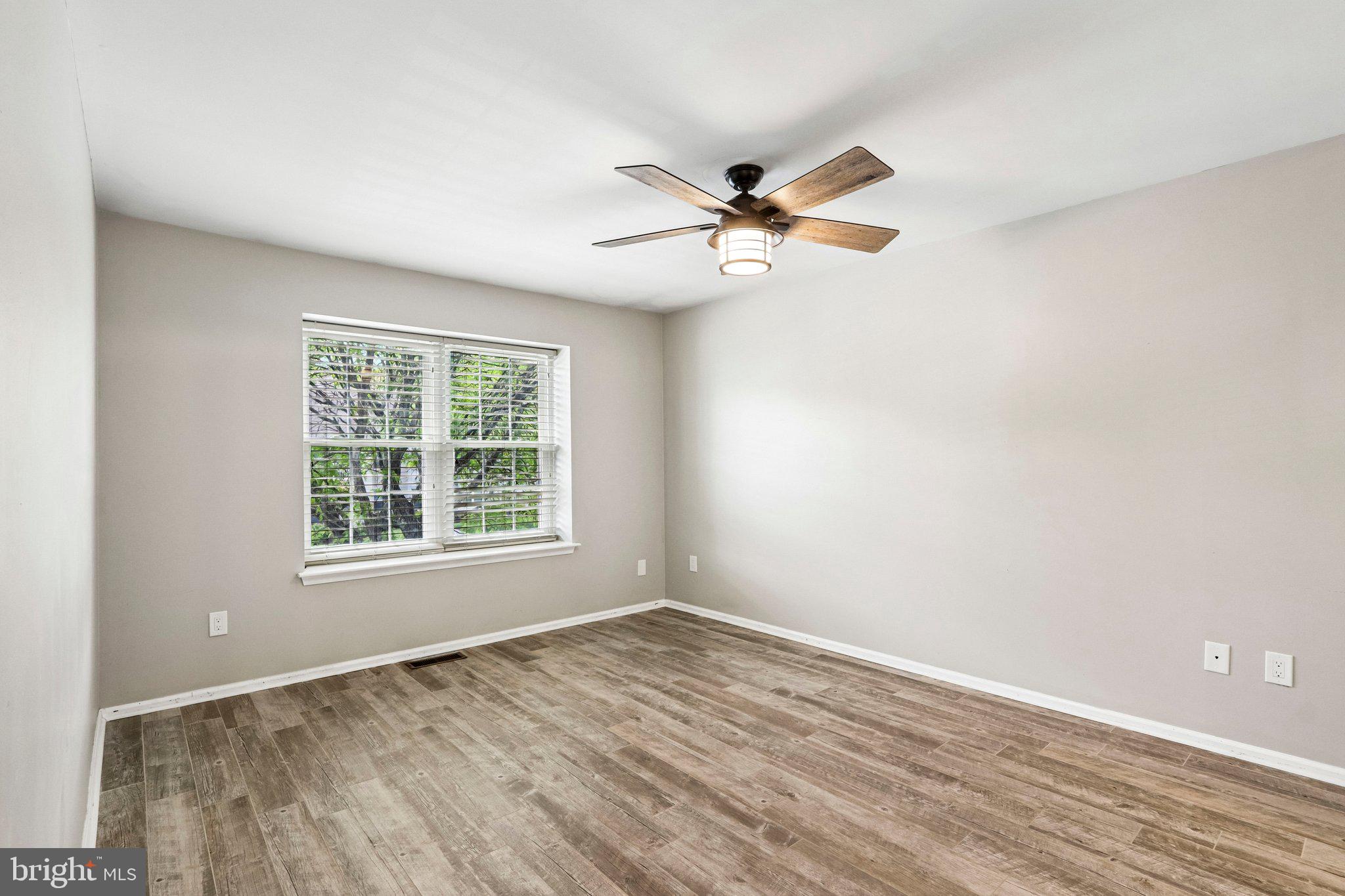 803 Wharton Road Mount Laurel, NJ 08054 - Photo 22 of 48 an empty room with wooden floor fan and windows