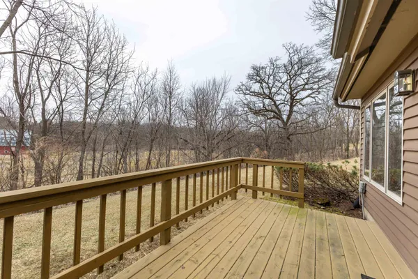 a view of balcony with wooden floor and fence