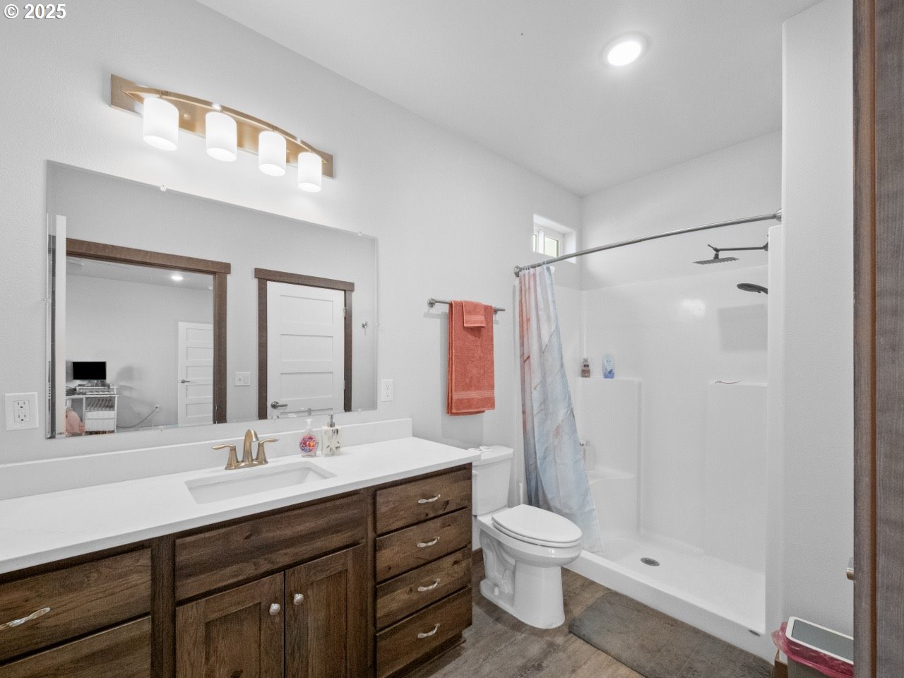 692 Southwest Runnion Avenue Pendleton, OR 97801 - Photo 15 of 35 a bathroom with a double vanity sink toilet mirror and shower