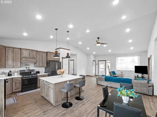 a large kitchen with a table and chairs