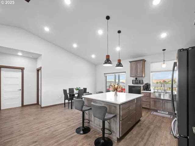 a kitchen with refrigerator cabinets dining table and chairs