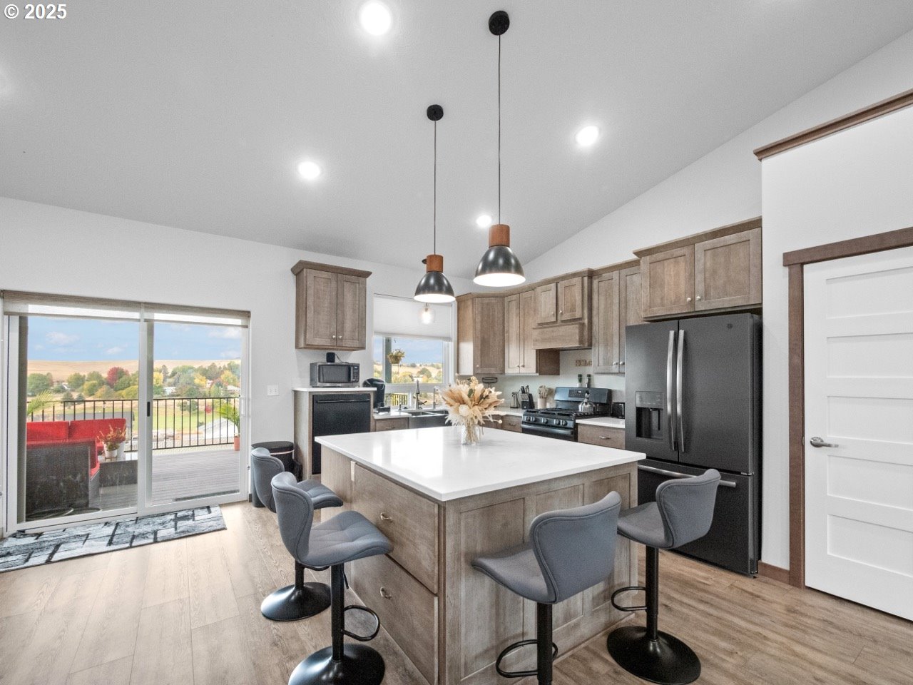 692 Southwest Runnion Avenue Pendleton, OR 97801 - Photo 7 of 35 a kitchen with refrigerator cabinets dining table and chairs