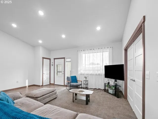 a living room with fireplace furniture and a flat screen tv
