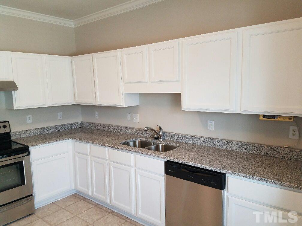5021 Village Lawn Drive Raleigh, NC 27613 - Photo 6 of 9 a kitchen with white cabinets and a sink