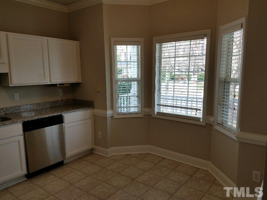 5021 Village Lawn Drive Raleigh, NC 27613 - Photo 7 of 9 a kitchen with a white cabinets and window