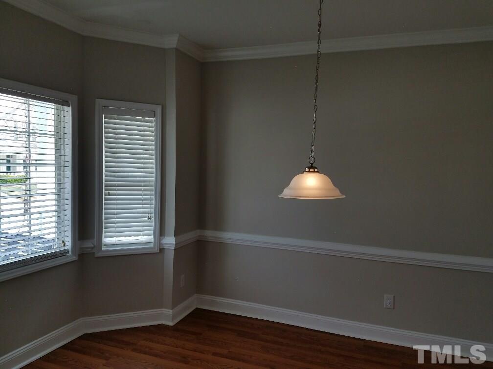 5021 Village Lawn Drive Raleigh, NC 27613 - Photo 8 of 9 a room with wooden floor and windows