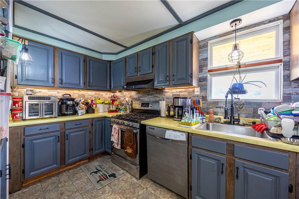 751 6th Street Pitcairn, PA 15140 - Photo 5 of 13 a kitchen with a sink window and cabinets
