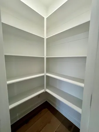 a storage room with wooden floor