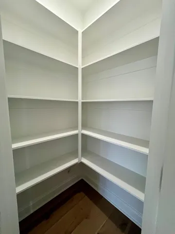 a storage room with wooden floor